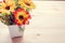 Flowers and pot on the office desk. Vintage tone