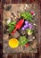 Flowers potting with red gardening scoop, roots and soil, on rustic wooden background, top view