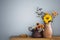 flowers in rustic ceramic vase on background gray wall