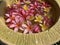 Flowers soaks in water in a pottery bowl. Onam and Diwali festival concept image, red plumeria flower or bunga kemboja merah in