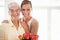 Flowers to show her appreciation. a young woman giving her mother a bunch of roses.