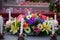 Flowers on the tomb at the cemetery with burning white candle