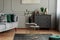 Flowers in vase on stylish coffee table in grey living room interior