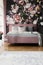 Flowers wallpaper in feminine pink bedroom interior with grey pi