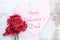 Flowers on wooden table with words Happy Valentines Day