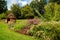 Flowery English Garden Scene with Small Hut