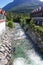 Flowing beautiful turquoise river water between houses in Hemsedal, Norway