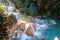 Flowing creek waterfall on a beautiful rocky rainforest landscape