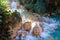 Flowing creek waterfall on a beautiful rocky rainforest landscape