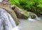 Flowing down from the rocks, the streams merge into a small pond