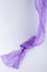 Flowing drape soft purple fabric on white background