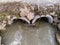 Flowing flooded mountain river through concrete pipes