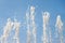 Flowing fountain water jets spray with blue bright sky background refreshing  macro wallpaper