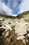 Flowing glacier stream among stones. Caucasus.