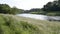 Flowing river through countryside in summer time