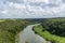 Flowing river among green trees