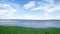 Flowing river and riverside landscape, panorama, blue sky and white clouds