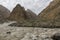 The flowing river under the snowy mountains