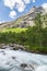 Flowing speed mountain river on sunny day