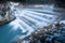 Flowing water over steps of river fall at winter