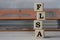 FLSA - acronym on wooden cubes on the background of a folder with documents