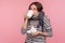 Flu treatment. Portrait of ill young woman wrapped in scarf drinking hot tea beverage, taking pills to treat