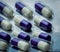 Fluconazole : Antifungal medicine. Full frame picture of purple, white capsule pills. Healthcare concept. Medicine pills