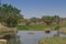 fluent river with rocks, vegetation, fisherman and boat in africa. Lubango. Angola.