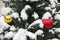 Fluffy branches of a Christmas tree in the snow decorated with