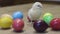 Fluffy chick clucking, easter eggs on wooden table. Newborn chicken. Little bird