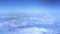 Fluffy clouds in blue sky from flying aircraft window. Aerial view white clouds in blue sky. Heaven copy space