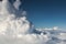 Fluffy clouds Cumulonimbus at high altitude over deep blue sky. Heaven, freedom, purity concept.