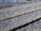 Fluffy fresh snow on a wooden railing close up