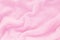 Fluffy Gentle baby pink fabric with waves and folds. Soft pastel