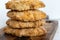 Fluffy homemade perrunillas, a typical Spanish cookie, are displayed on a wooden board against the cool marble background.