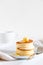 Fluffy Japan souffle pancakes, hotcakes with butter and maple syrup or honey sauces on light white background