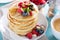 Fluffy oatmeal pancakes stack with fresh berries