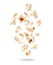 Fluffy popcorn scattered in the air closeup on a white background. Randomly falling popcorn