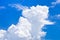 Fluffy and relief clouds in blue sky, big cumulus