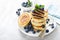 Fluffy souffle pancakes with chocolate filling and fresh blueberry for breakfast