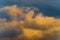 Fluffy thunderstorm clouds illuminated by disappearing rays at sunset, thunderclouds floating across sunny blue sky to change