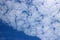 Fluffy white altocumulus clouds in blue sky