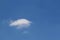 Fluffy white cloud against a clear blue sky