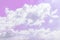 Fluffy white clouds on a pink background float in the sky. Dream. Femininity