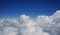 fluffy white cumulus clouds on blue sky background