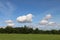 Fluffy white cumulus clouds in a blue summer sky over the Shropshire landscape, UK