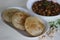 Fluffy whole wheat fried Indian flat bread, served along with Spicy chickpea gravy. Locally known as Chole puri