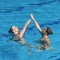 Fluid grace and synchronized beauty of a female duet, dancing in perfect harmony in the mesmerizing aquatic ballet of synchronized