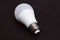 Fluorescent light bulb base on black background