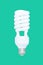 Fluorescent spiral light bulb isolated on green background